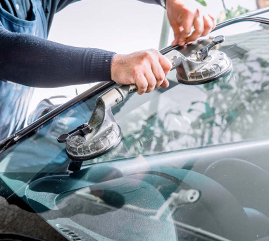 parramatta smash repair technician fitting windscreen on car