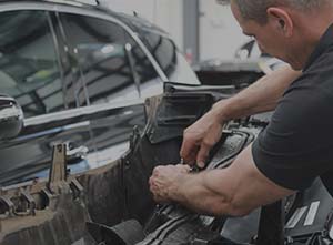 parramatta smash repair technician fitting side panel on car